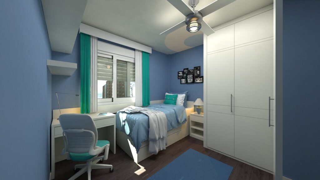 Small dorm room with blue walls and a white closet