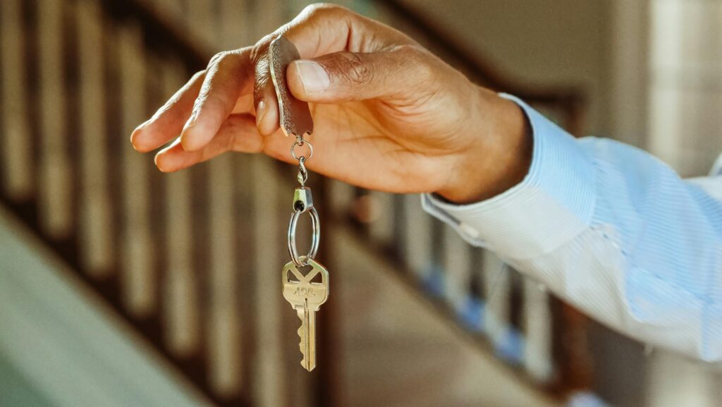 A man holding an apartment key